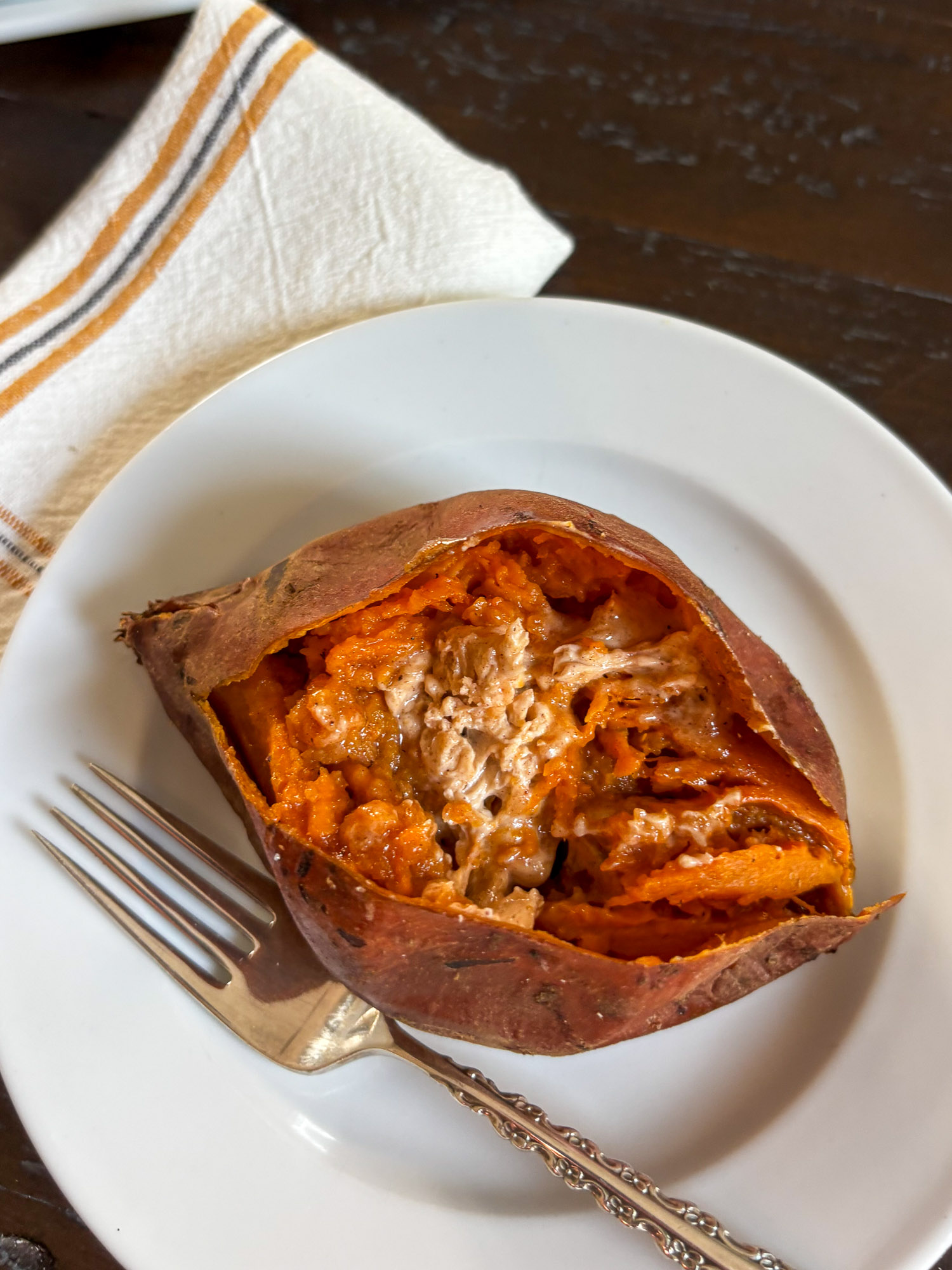Baked Sweet Potatoes with Harvest Honey Butter-4 Baked sweet potato split open and filled with creamy shredded chicken on a plate