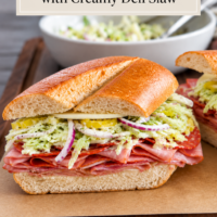 talian grinder sandwich layered with deli meats, cheese, pickles, red onion, and creamy deli slaw on crusty bread.